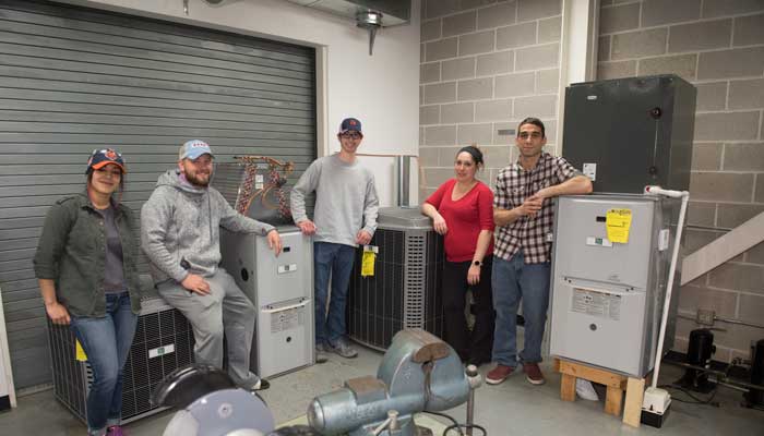 Moraine Valley Community College students in the Heating and Air Conditioning Program are surrounded by donated state-of-the-art equipment.