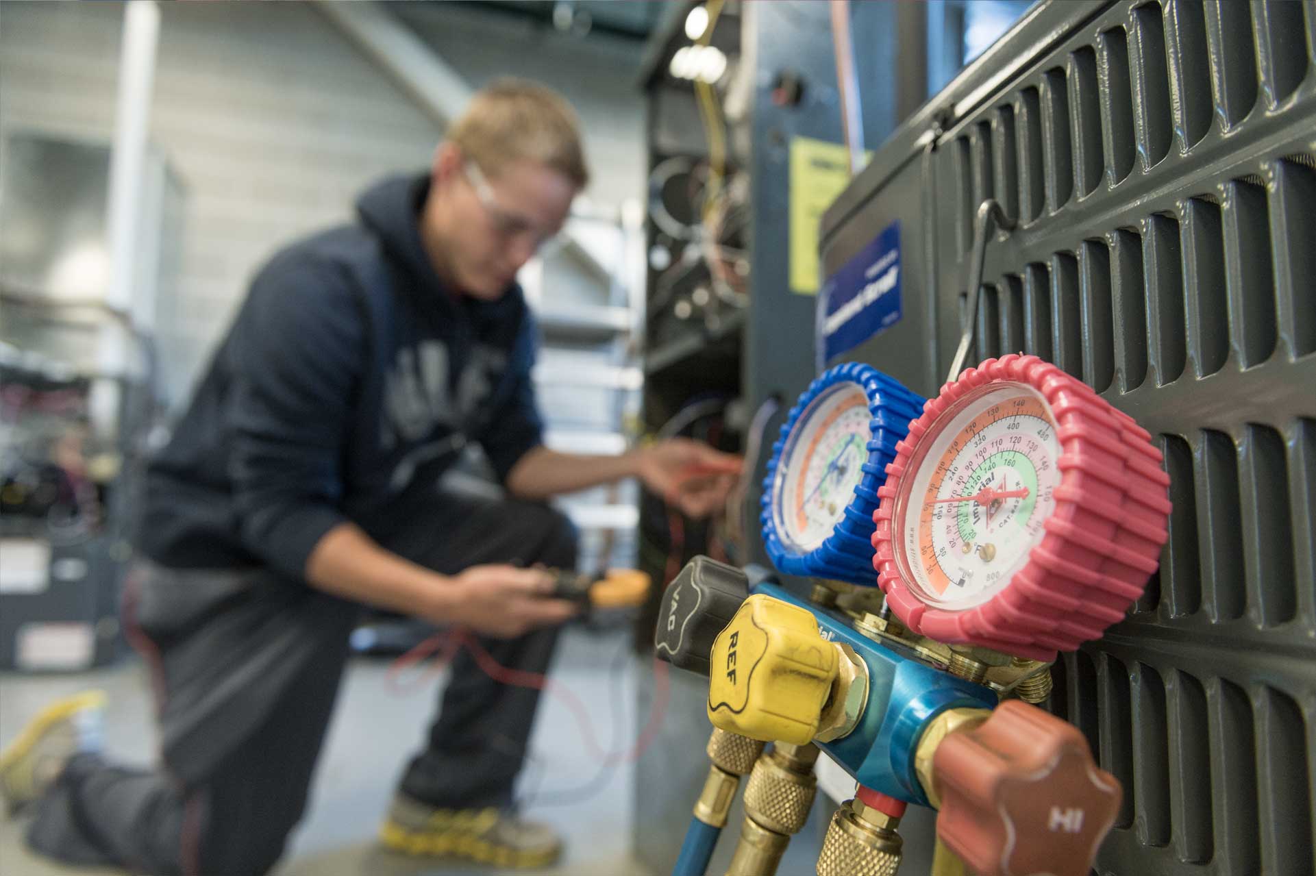 man checking dials of air conditioning unit