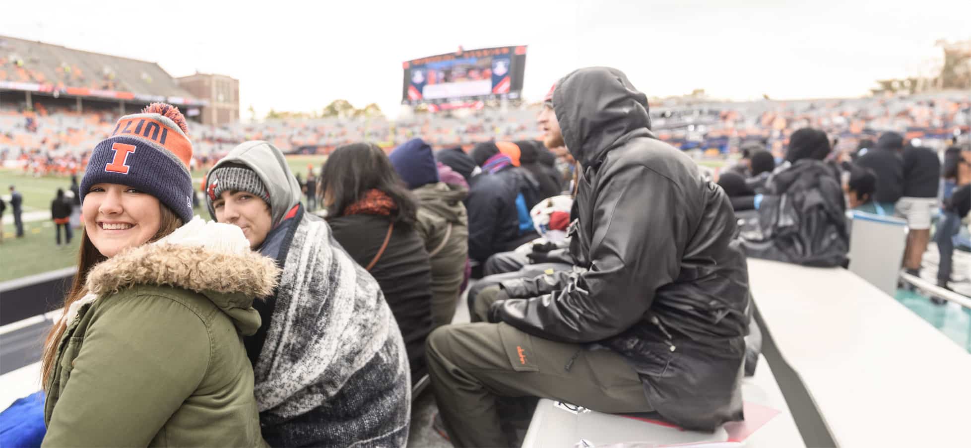 Students sitting at a University of Illinois football game