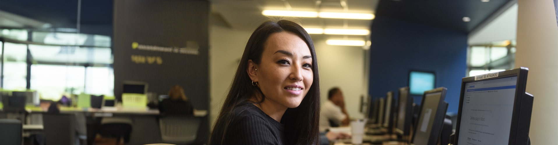 Woman sitting at computer smiling