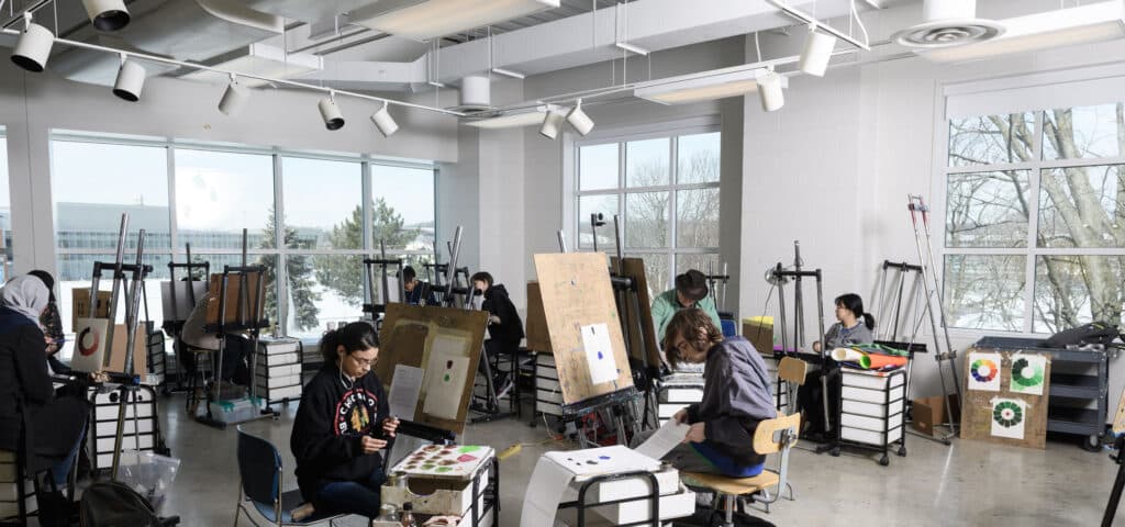 Painting studio - large room with high ceilings an natural light. canvases set up around the rooms.