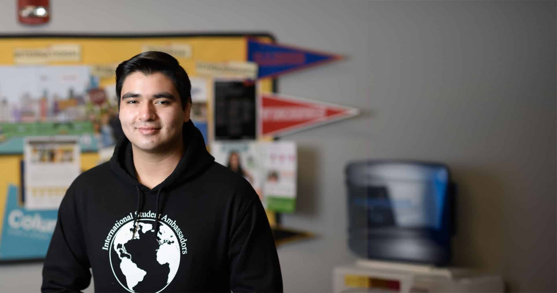 International student standing in the ISA office