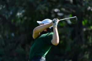 A men's golfer takes a swing during an outing