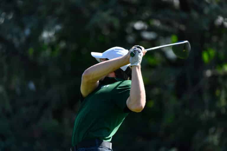A men's golfer takes a swing during an outing