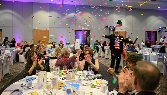 Round table in facility rental room with people sitting at an event