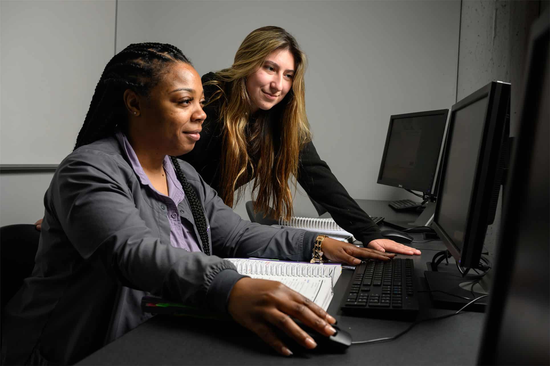 Two women sitting at a computer