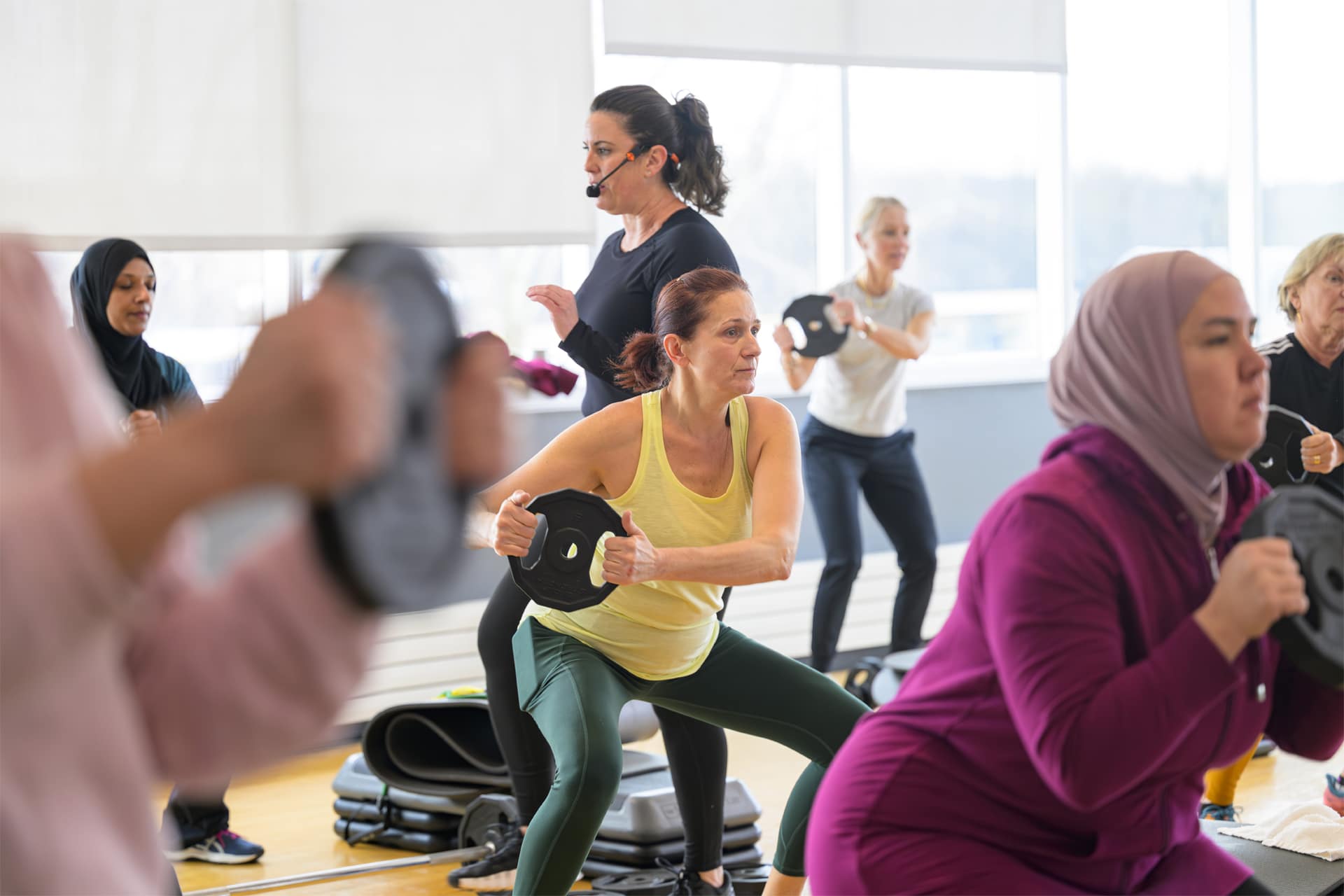 Gym workout room - several people doing squats