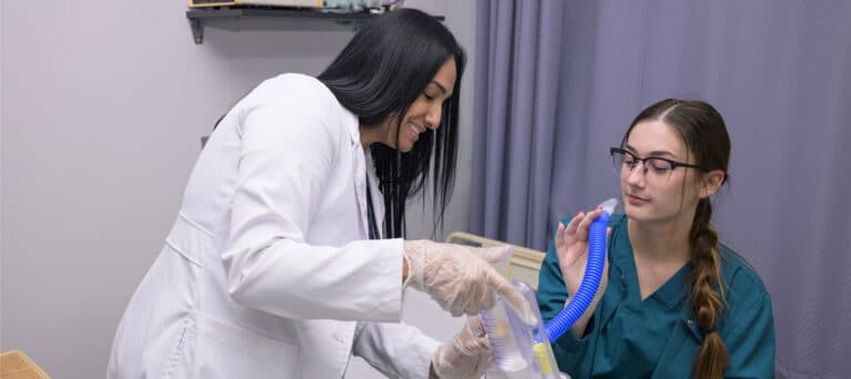 Two students practicing respiratory exercises
