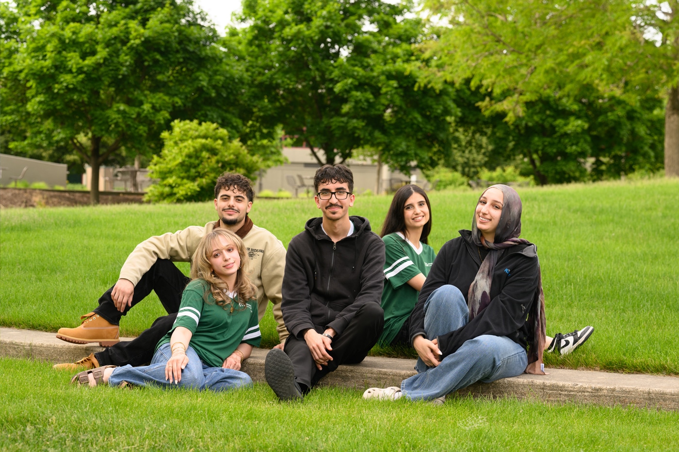 New Student Orientation students sitting in the grass together.