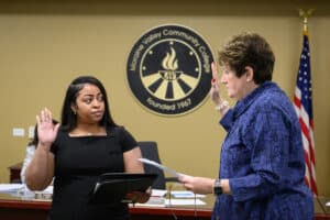 Stefanie DaCosta (left) takes the oath of office as the new student trustee at Moraine Valley Community College from Beth McElroy Kirkwood