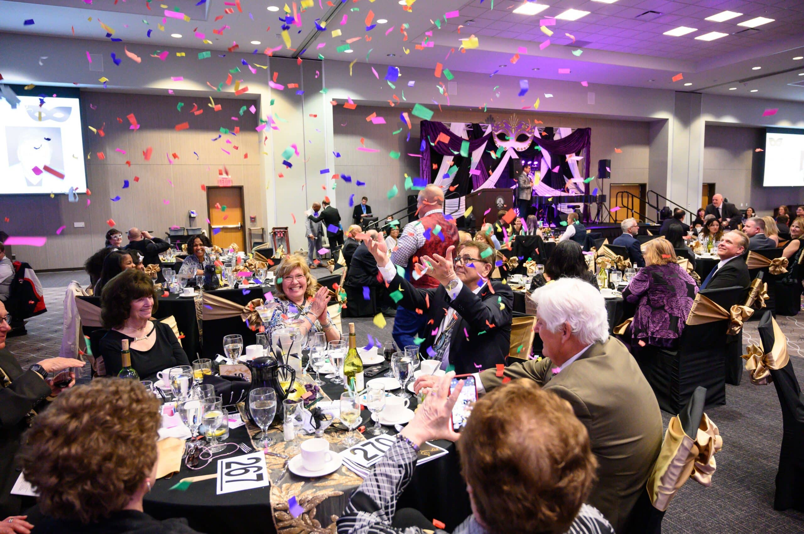 Confetti flies after a winning bid during the Moraine Valley Foundation’s “Mask-erade Night” Fundraising Gala event that raised money for Moraine Valley Community College.