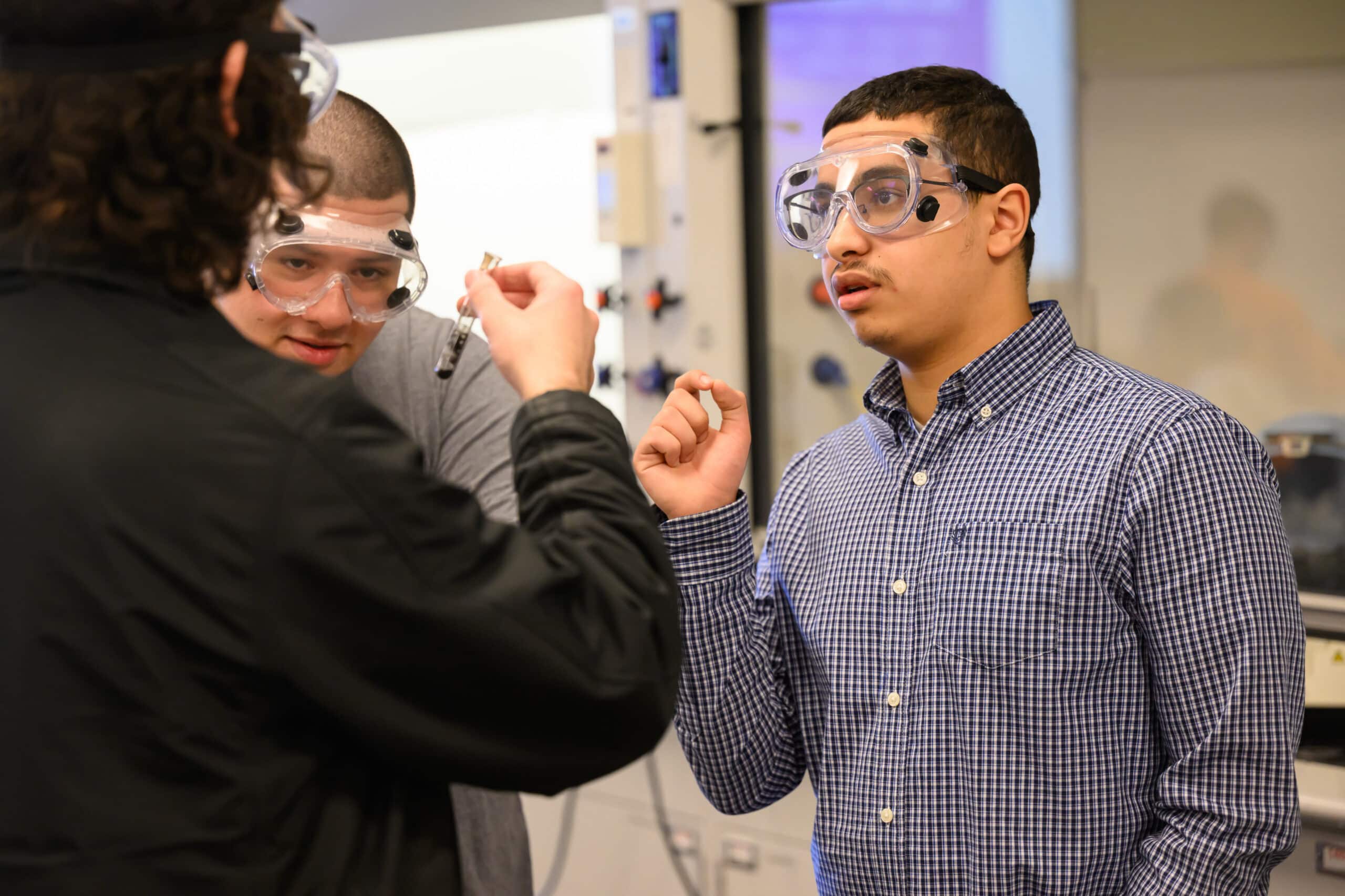 Greer Scholars Amin Kamni, Nicholas Barragan and Liam Deacy work on a lab assignment during their chemistry class.