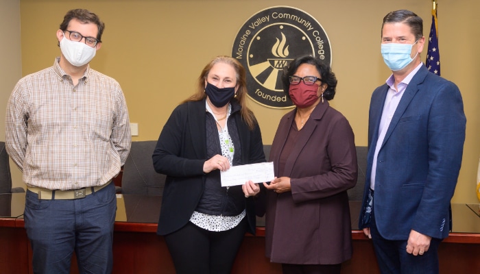 Founder and CEO of Maribis and Bedford Grow, Laurel Dineff (second from left), gives an $80,000 donation from Maribis to start a new endowed scholarship to Moraine Valley Community College’s president, Dr. Sylvia M. Jenkins. Also pictured: Thomas Kantas, president of the Moraine Valley Foundation Board (far left), and Paul Chialdikas, vice president of Bedford Grow.